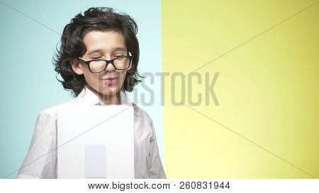 Portraits Of A Teenager In School Uniform And Glasses On A Colored Background. Funny Guy. Concept Of