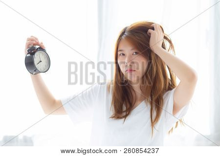 Beautiful Young Asian Woman Wake Up In Morning Annoyed Alarm Clock Holding Hand, Standing Hurry Wake