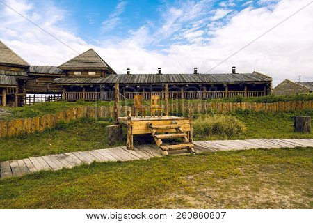 Two Chairs Stand On A Wooden Platform On The Background Of The Fortress