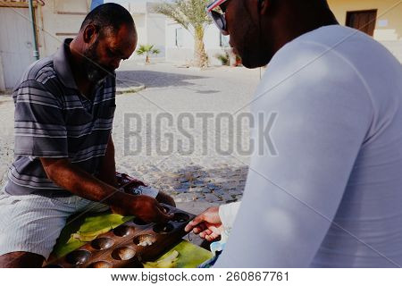 Palmeira, Sal Island, Cape Verde - Jan 5 2016: Local Villager Man Playing Ouril Game At The Main Squ