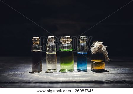 Various Magic Potions Or Colorful Essential Oils In The Bottles On The Table.