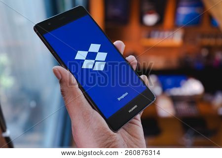 Chiang Mai, Thailand - April 21,2018: Man Holding Huawei With Dropbox On Screen. Dropbox Is A Servic