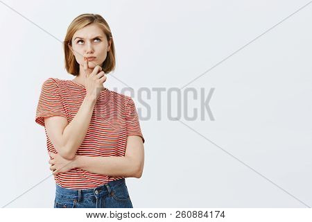 Thinking, Making Important And Hard Choice In Mind. Thoughtful Intense Attractive And Young Girl Wit