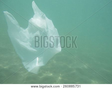 Plastic Bag Floating Into The Sea. Polluted Enviromental. Recycle Garbage