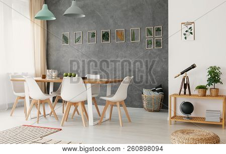 Open Space Living And Dining Room Interior With Wooden Furniture, Stylish Decor And A Plant Leaves G