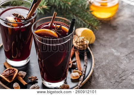 Hot Mulled Wine With Spices, Apple And Orange On Chrictmas Background. Copy Space.