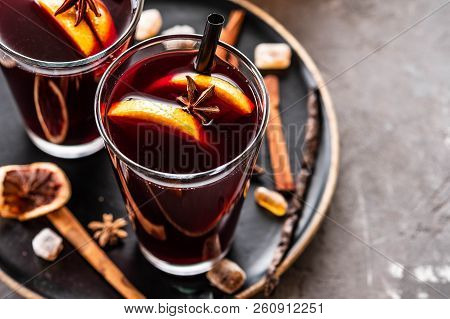 Hot Mulled Wine With Spices, Apple And Orange On Chrictmas Background. Copy Space.