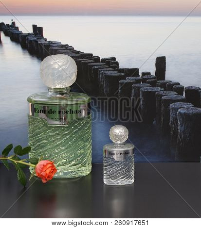 Eau De Rochas, Fragrance For Ladies, Large Perfume Bottle Next To A Commercial Perfume Bottle In Fro
