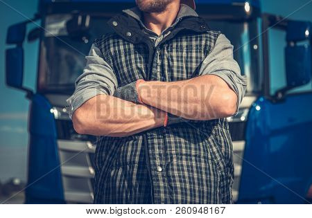 Truck Driver Workhorse. Caucasian Men In Front Of His Vehicle With Crossing Arms. Powerful Transport