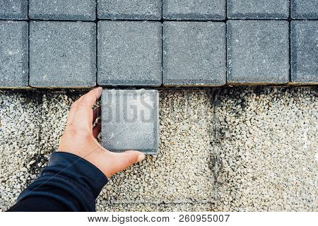 Paving Blocks. Hand Holds And Install Paving Block