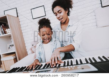 Mother With Daughter Play On Piano. Mother Help Girl With Piano. Positive Emotion. Smile Girl And Sm