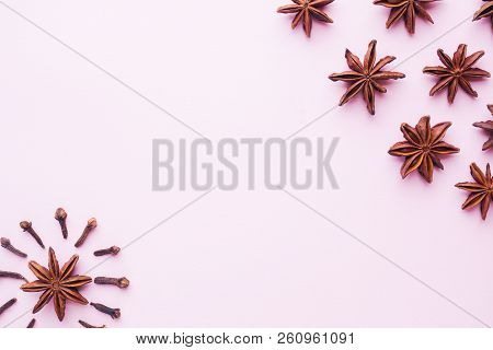 Composition Of Star Anise And Cloves On Pink Background. Abstract Flat Pattern, Top View..