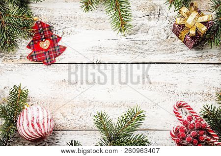 Christmas Composition With Fir Tree Branches And Red Christmas Decorations On White Wooden Backgroun