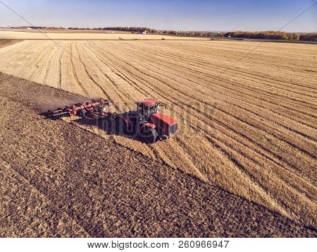 Tractor Working In The Fields, Aerial View, Hay On The Field. The View From The Top. Tractor Harvest