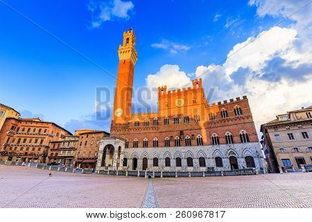 Siena, Italy. Palazzo Publico And Piazza Del Campo At Sunset.