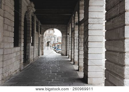 Chioggia, Italy-august 26, 2018: Province Of Venice. Street With An Arch And Columns.