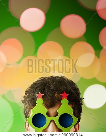 Portrait Photo Of Smiling Nerdy Guy With Christmas Tree Glasses. Copy Space For Text. Vertical 4x5 C
