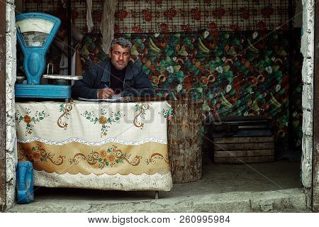 Lankaran, Azerbaijan - Apr 18 2011: Local Man Waiting At His Business For Customers To Arrive At The