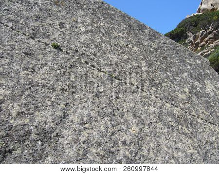 Granite Rocks Closeup, Natural Texture Pattern With Blue Sky In The Background