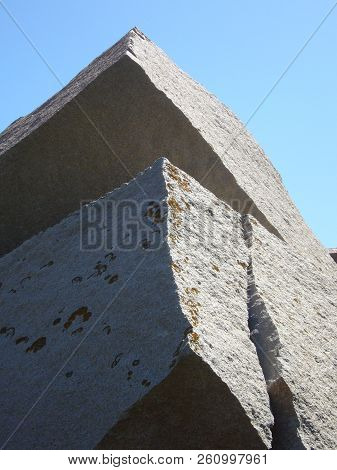 Granite Rocks Closeup, Natural Texture Pattern With Blue Sky In The Background