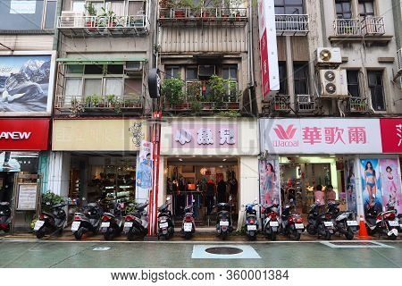 Keelung, Taiwan - November 23, 2018: Parked Motor Scooters And Fashion Shops In Keelung, Taiwan. Kee