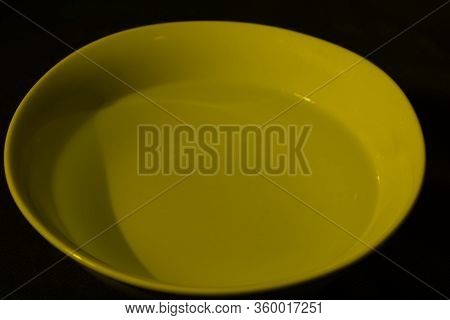 White Bowl Filled With Water On Black Background