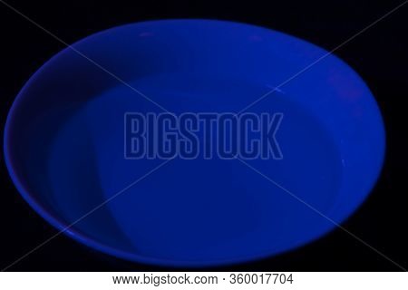 White Bowl Filled With Water On Black Background