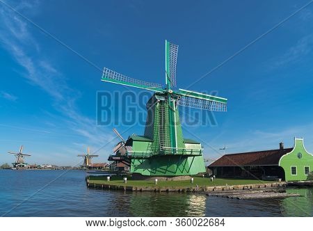 Traditional Windmill In The Zaanse Schans, A Neighborhood With Historic Wooden Buildings In The Muni
