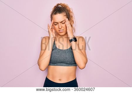 Young beautiful blonde sportswoman with blue eyes doing exercise wearing sportswear with hand on headache because stress. Suffering migraine.