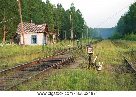 Old Russian Railway Line And Station With Half-grown Tracks