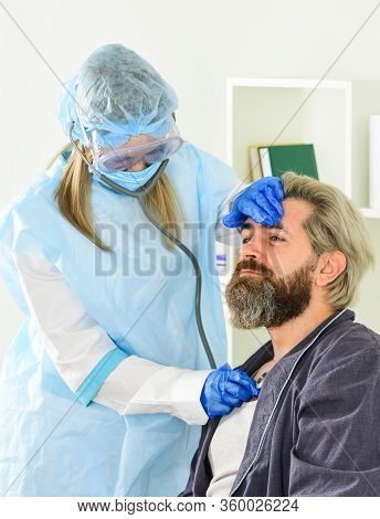 Covid 19. Diagnosis Of Pneumonia. Sars Concept. Doctor Protective Equipment Examines Patient Suspect