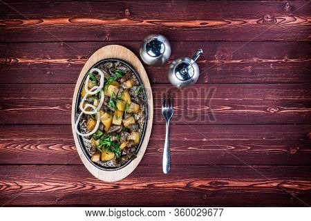 Kuurdak - Traditional Meat Dish Made In Central Asia. Serving On A Hot Frying Pan. Top View