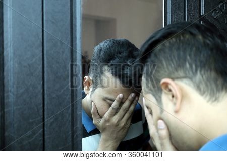 A Man With Hands On His Face In Front Of A Mirror In Depressed Mood With Selective Focus On Mirror I