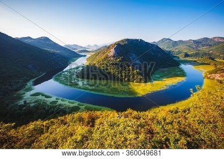 Picturesque scene of winding river Rijeka Crnojevica flowing through mountains. Location National park Skadar Lake, Montenegro, Balkans, Europe. Perfect wallpapers. Discover the beauty of earth.