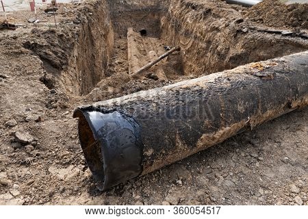 repair and replacement main pipeline of heating systems, district heating pipes network, water supply or Sewerage in city, removing old pipes and replacing them with new ones in a hole in the ground