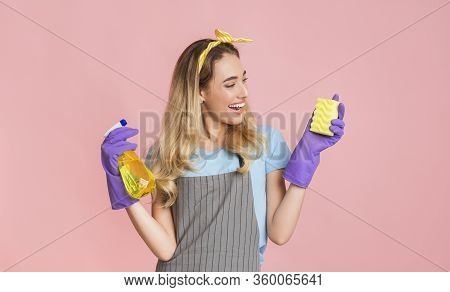 Household Chores With Fun. Housewife Holds Spray And Sponge