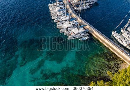 Croatia, Maslinica, 15 September 2019: Drone View Point On Moored In An Equal Row Sailboats At Sunse