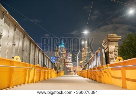 Melbourne Australia - March 14 2020; Night Scene On And Across Sandridge Pedestrian Bridge Buildings