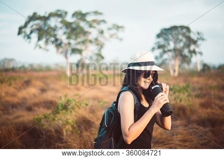 Happy Traveller Asian Woman Drinking Water From The Bottle In Spending Time At Forest,lifestyle Trav