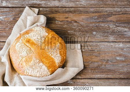 One Bun Of Freshly Baked Yeastless Bread Wooden Rustic Background. The Concept Of Home-made Diet Bak