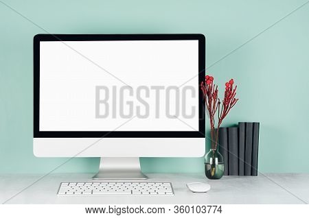 Elegant Spring Home Workplace With Blank Computer Screen, Black Books, Keyboard, Mouse, Red Plant In