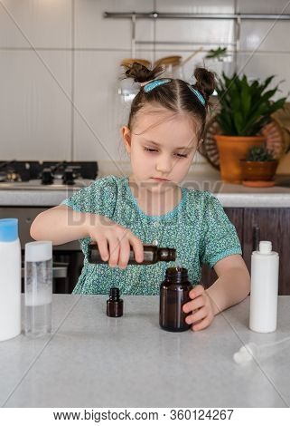 Kid Girl Makes Sanitaizer Or Antiseptic Gel At Home. Hygiene During Coronavirus Epidemic. Concept Of