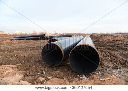 Sections Of Pipe On Top Of Wooden Supports At An Construction Site For Natural Gas. Construction Of