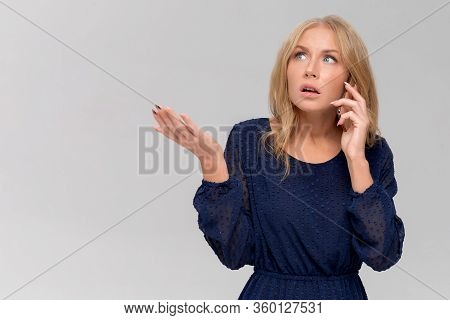 Headshot Of Shocked Millennial Woman Having Argument Talking Via Smartphone. Angry Young Female Spea