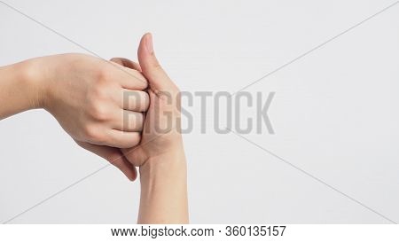 Male Model Is Interlock Fingers And Rub Mid-joints On White Background.