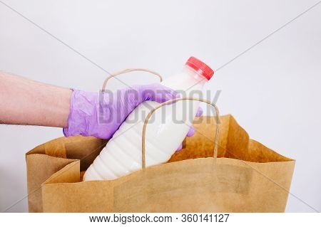 Wiping Down Grocery Packages After Receiving Home Delivery Wearing Gloves