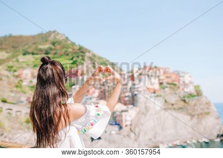 Happy Girl Making With Hands Heart Shape On The Old Coastal Village In Cinque Terre National Park.