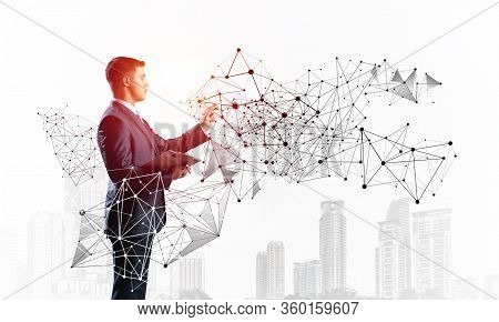 Business Person Pointing On Abstract Network Structure. Standing Personal Assistant In Business Suit