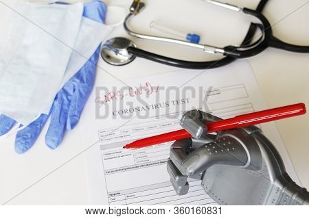 The Robot Writes Sars-sov-2. Coronavirus Test Concept. Robotic Medicine Concept. On The Table Are A 