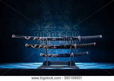 Three Swords On Stand, With Dramatic Blue Light